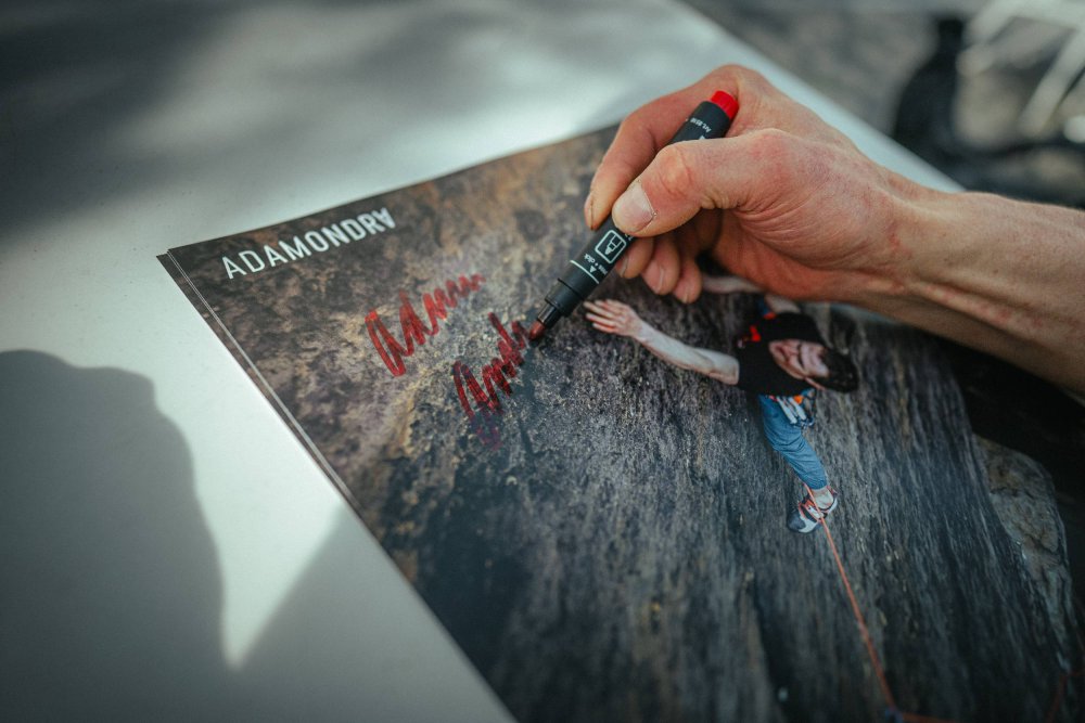 Adam Ondra signing (in detail) his poster from Saxony Sandstone climbing
