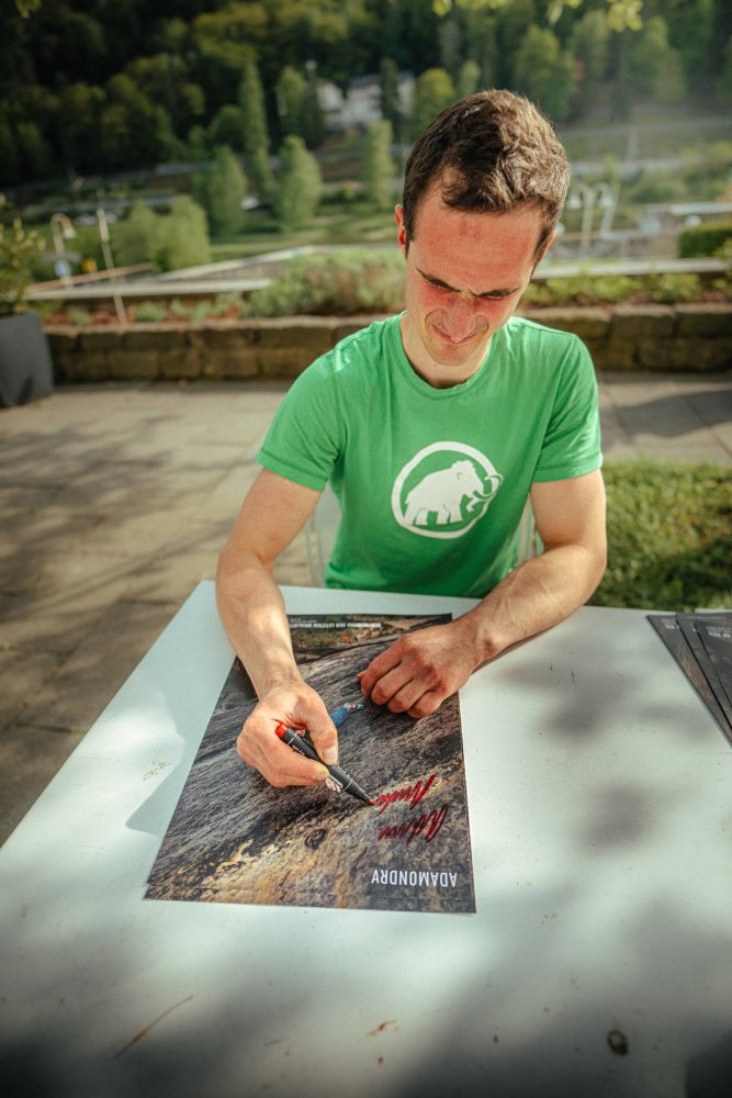 Adam Ondra signing his poster from Saxony
