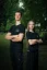 Adam Ondra and a woman model posing in the AO "I hate toehooks" black T-shirt, front side