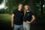 A man and a woman posing in the Adam Ondra "I hate toehooks" black T-shirt, front side