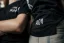 Detail of Adam Ondra logo on his " I hate toehooks" black T-shirt
