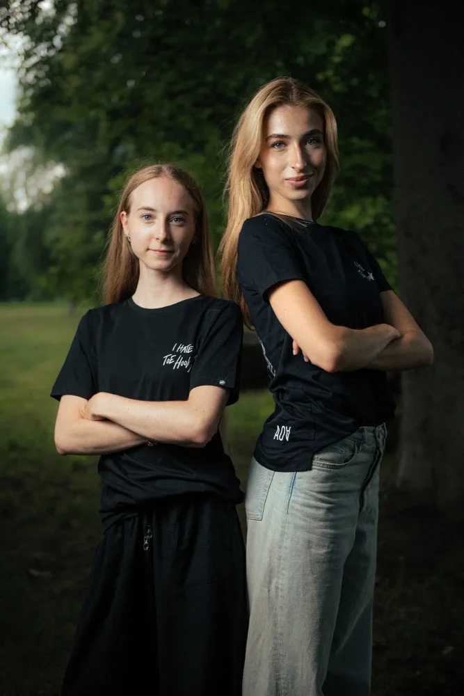 Two women posing in Adam Ondra "I hate toehooks" black T-shirt, front side