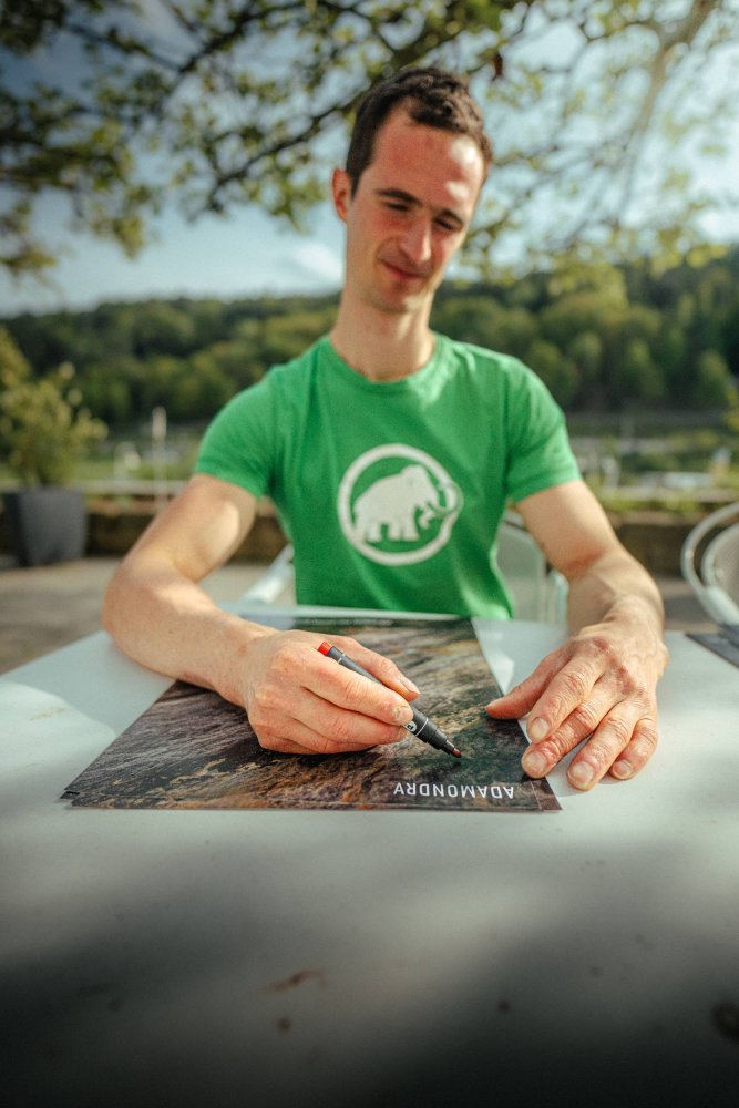 Adam Ondra signing his poster from Saxony Sandstone climbing