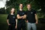 Adam Ondra and two models posing in the AO "I hate toehooks" black T-shirt, front side