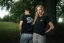 A man and a woman posing in the Adam Ondra "I hate toehooks" black T-shirt, front and back side