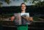 Adam Ondra posing with his Circus Maximus poster, landscape version