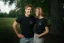 A man and a woman posing in the Adam Ondra "I hate toehooks" black T-shirt, front side