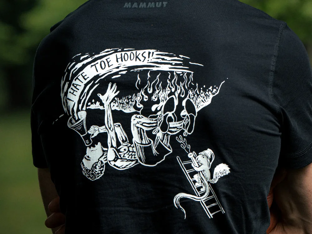 Detail of the "I Hate Toehooks" art on the back side of Adam Ondra black men's T-shirt