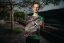 Adam Ondra holding his signed Saxony Sandstone poster